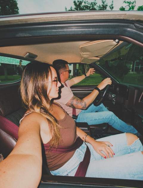 A candid moment between two people inside a car