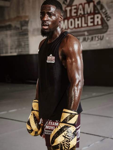 An athlete wearing boxing gloves after training